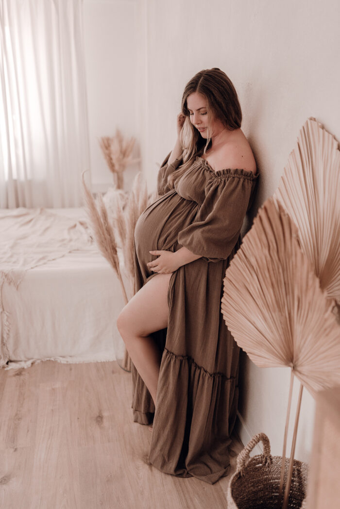 Schwangere Frau fotografiert von einfallslicht fotografie bei Babybauch Shooting in Düsseldorf inklusive Schwangerschaftskleidung im Tageslichtstudio in Düsseldorf