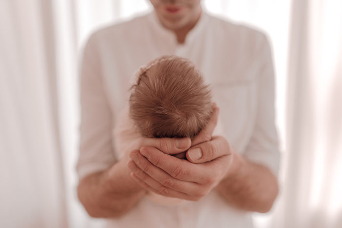 Papa und Baby beim Neugeborenen Shooting, Geschwisterliebe, Familienshooting bei einfallslicht fotografie in Düsseldorf, Baby, Babykleidung, Babybody